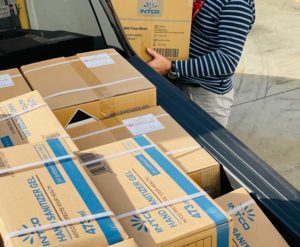 A man loading non-food items into the back of a truck.