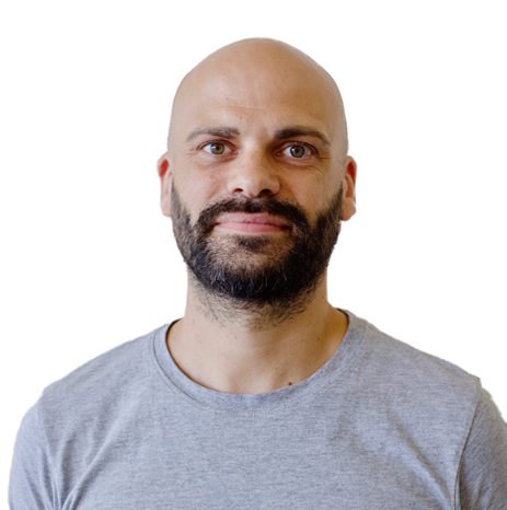 A bald man with a beard is standing in front of a white background, ready to host events and webinars.