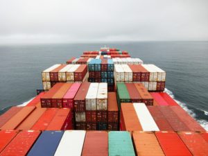 A sea freight container ship is traveling in the ocean.