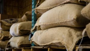 Food items, such as coffee sacks, stacked on pallets in a warehouse.