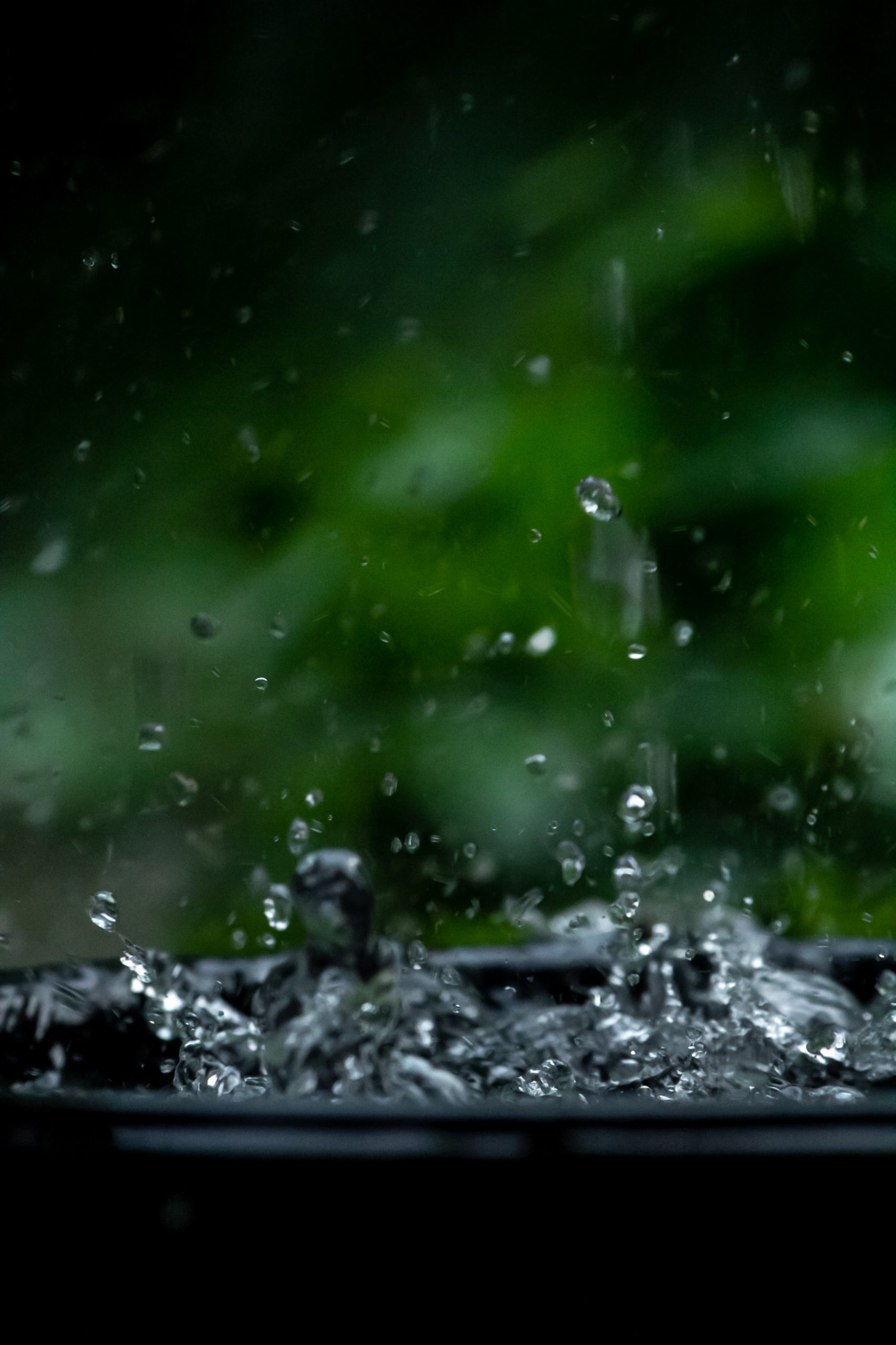 Water splashing into a black bowl at a climate solutions accelerator event.