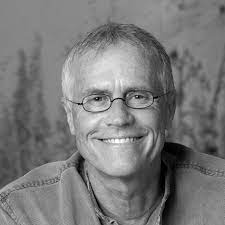 A black and white photo of a man smiling, showcasing climate solutions acceleration.