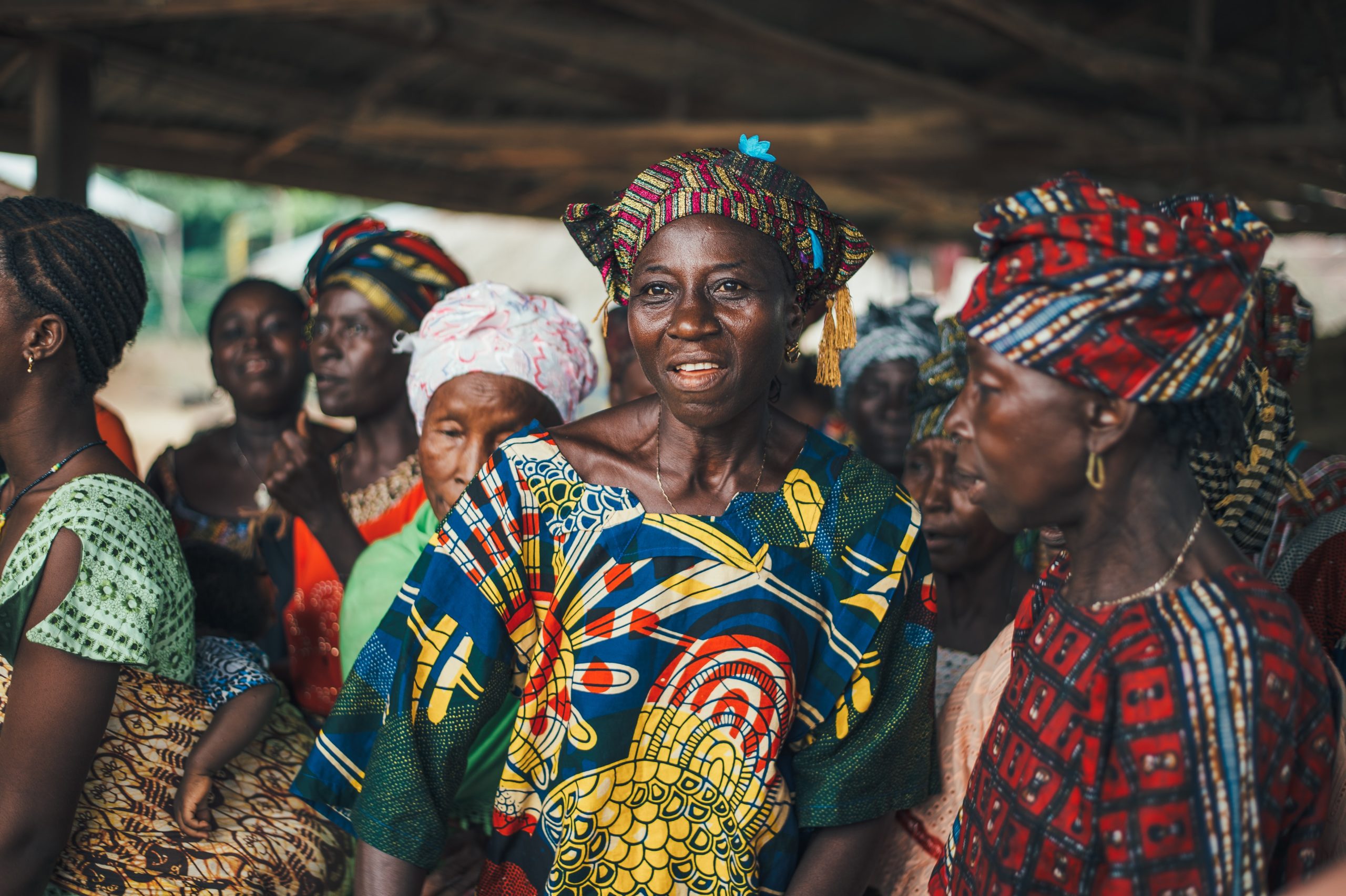 A group of women dressed in traditional African clothing, promoting climate action and climate solutions.