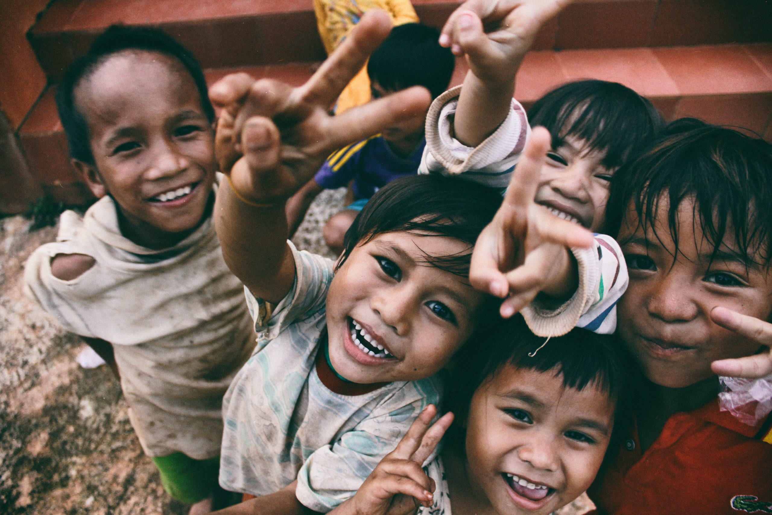 A group of children are posing for a photo, acting out a roadmap.